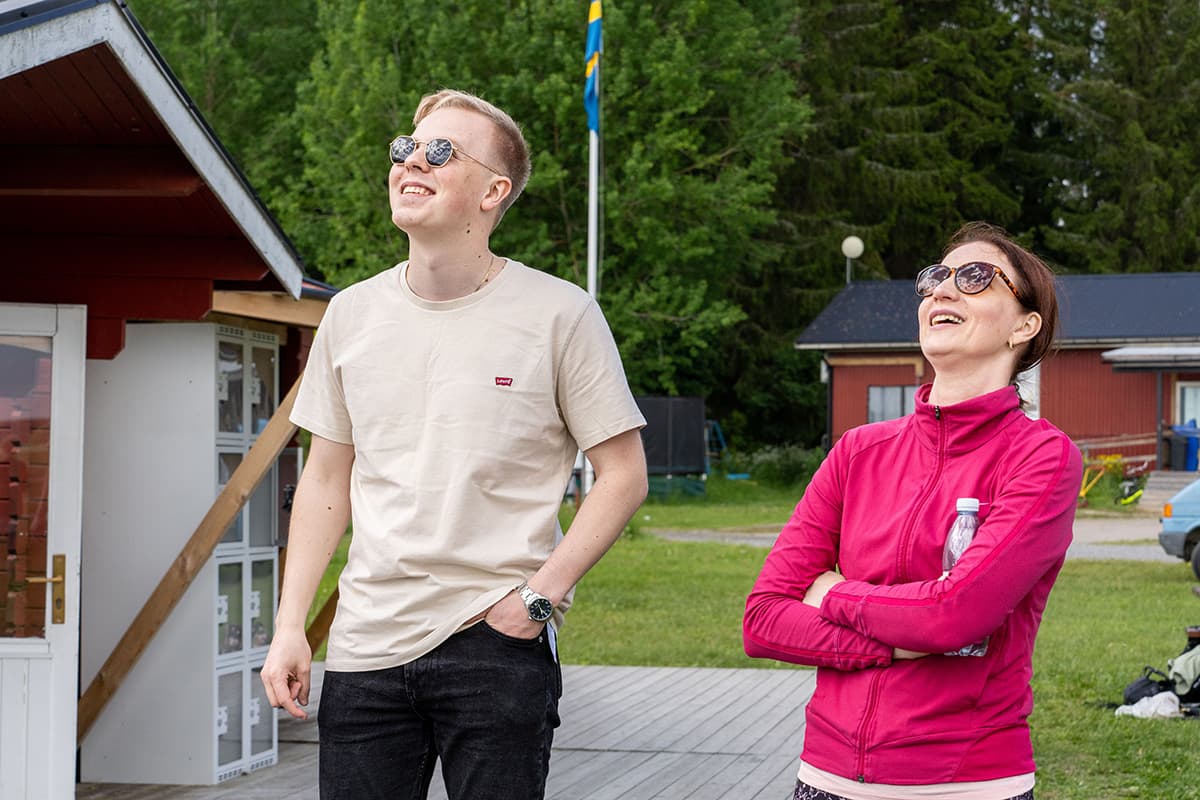 Two people looking at the sky.