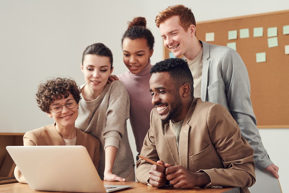 People gathered around a computer